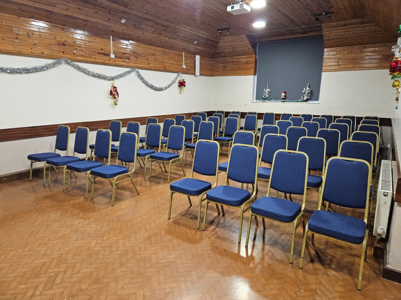Hall with seating in cinema style Empty hall with rows of blue chairs arranged in a neat layout.